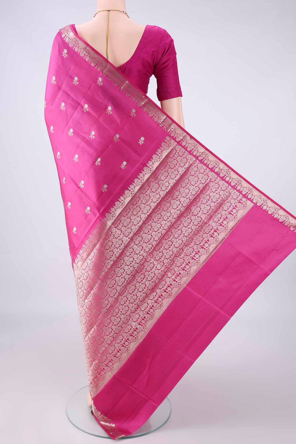 Flat view of Pure Silk Rani Pink Banarasi Raw Saree with Zari Butta on the body and Zari Border. 