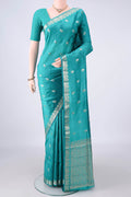 Pure Silk Turquoise Banarasi Raw Saree with Zari Butta on the body and Zari Border.  displayed on a mannequin