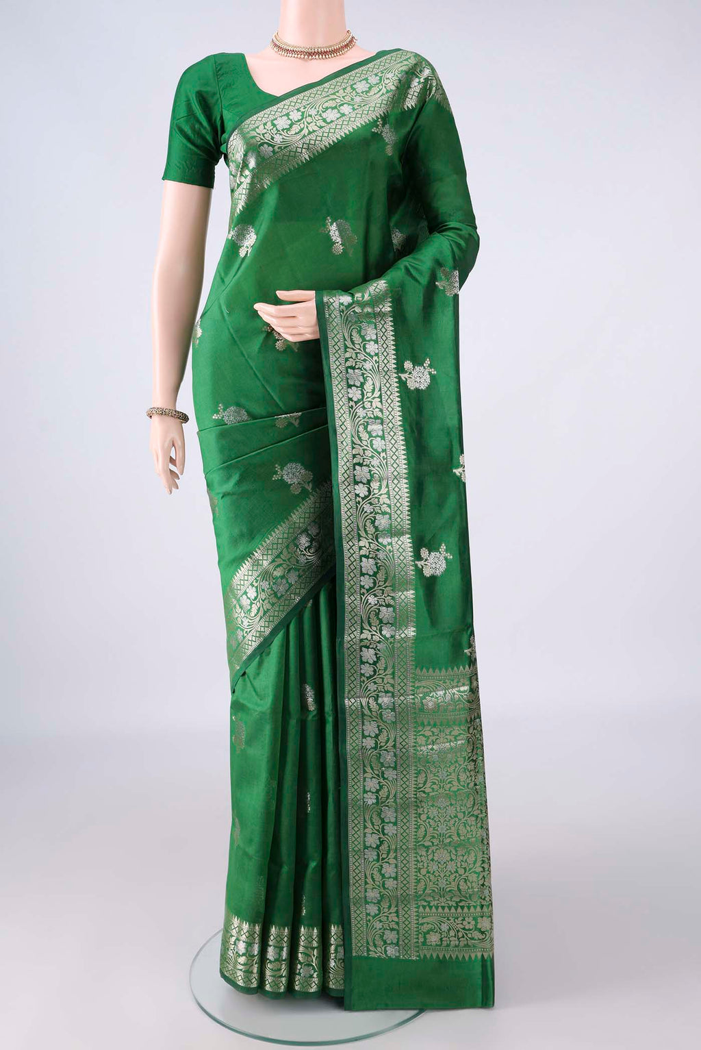 Pure Silk Green Banarasi Raw Saree with Zari Butta on the body and Zari Border.  displayed on a mannequin