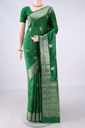 Pure Silk Green Banarasi Raw Saree with Zari Butta on the body and Zari Border.  displayed on a mannequin