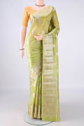 Pure Silk Light Green Banarasi Raw Saree with Zari Butta on the body and Zari Border.  displayed on a mannequin