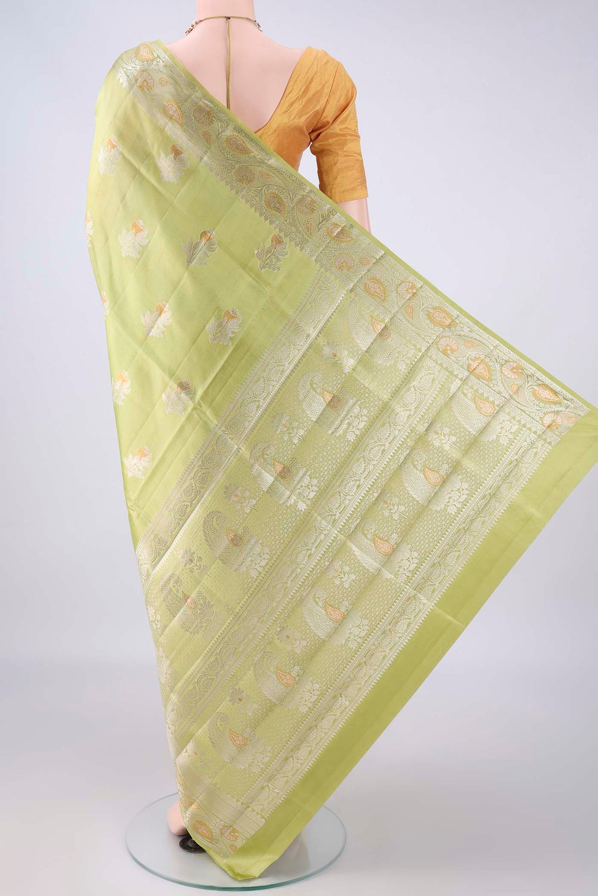 Flat view of Pure Silk Light Green Banarasi Raw Saree with Zari Butta on the body and Zari Border. 