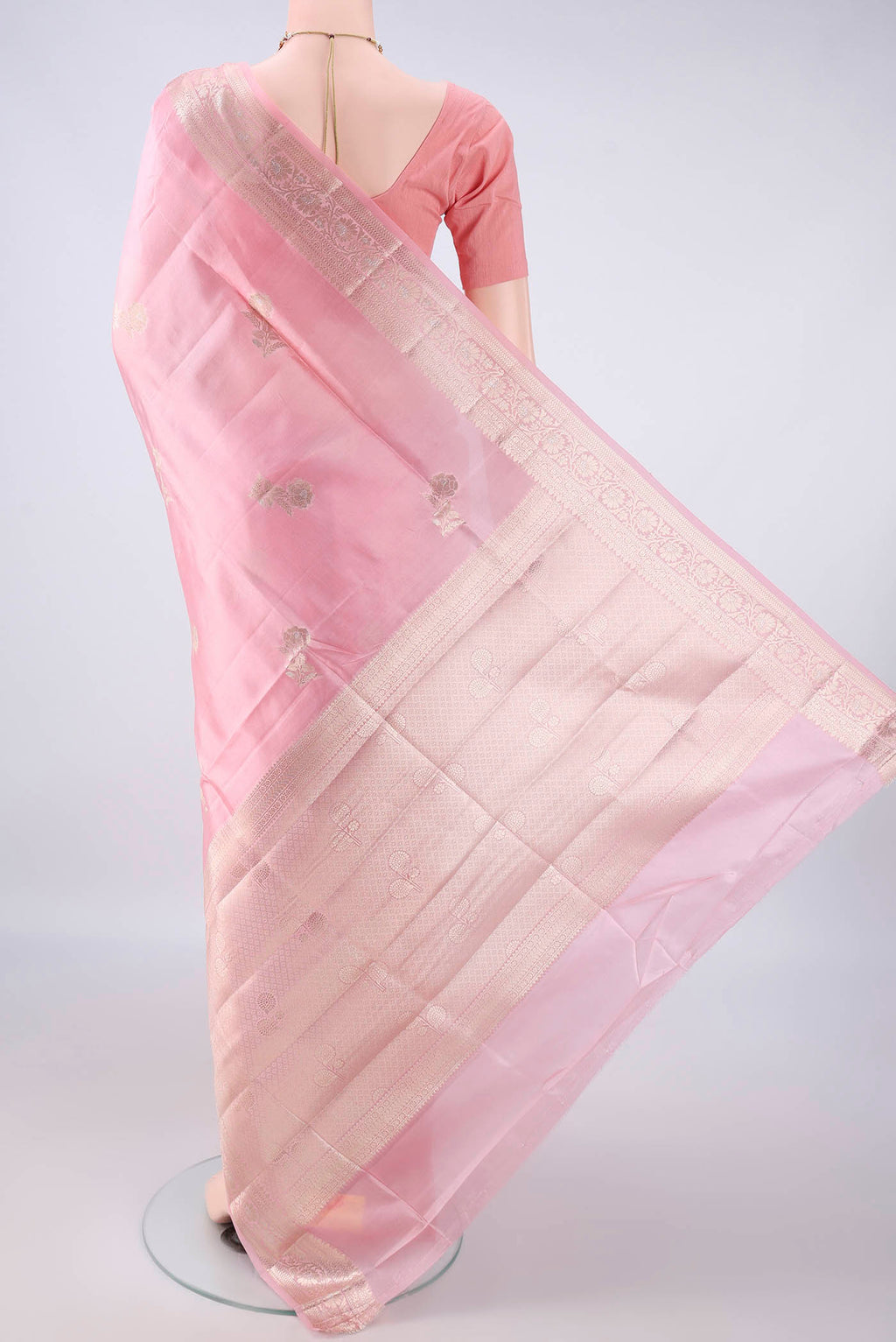 Flat view of Pure Silk Rose pink Banarasi Raw Saree with Zari Butta on the body and Zari Border. 