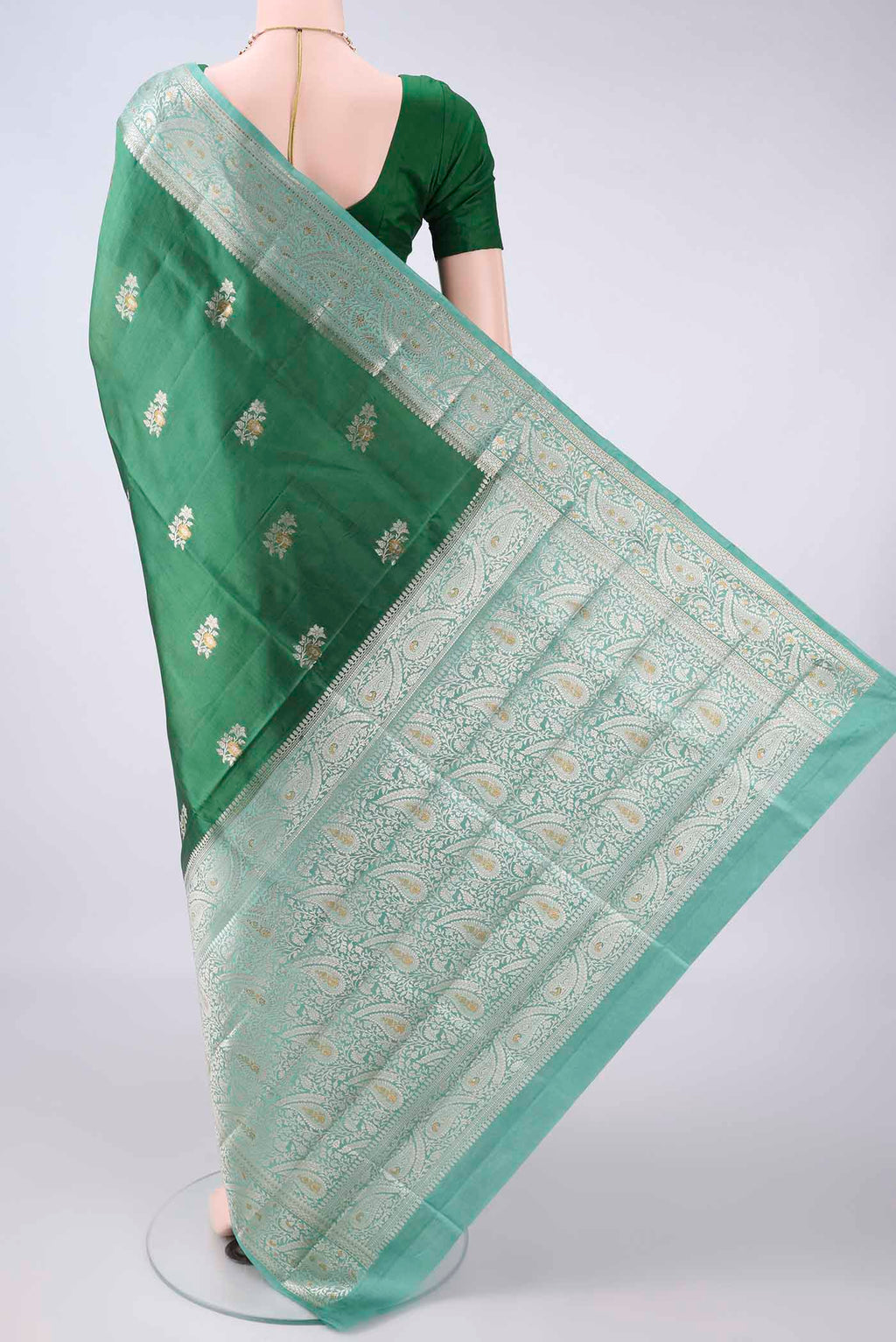 Flat view of Pure Silk Bottle Green Banarasi Raw Saree with Zari Brocade on the body and Zari Border. 