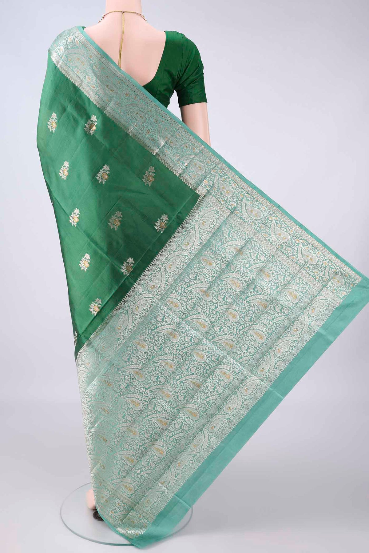 Flat view of Pure Silk Bottle Green Banarasi Raw Saree with Zari Brocade on the body and Zari Border. 