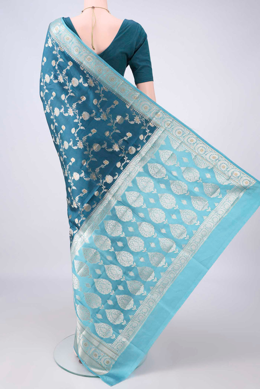 Flat view of Pure Silk Teal Banarasi Raw Saree with Zari Brocade on the body and Zari Border. 