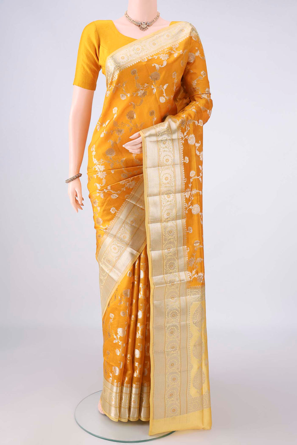 Pure Silk Yellow Banarasi Raw Saree with Zari Brocade on the body and Zari Border.  displayed on a mannequin