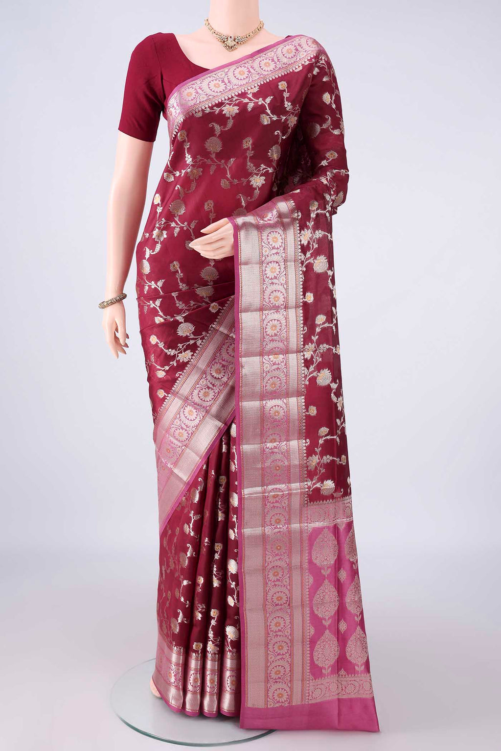 Pure Silk Maroon Banarasi Raw Saree with Zari Brocade on the body and Zari Border.  displayed on a mannequin