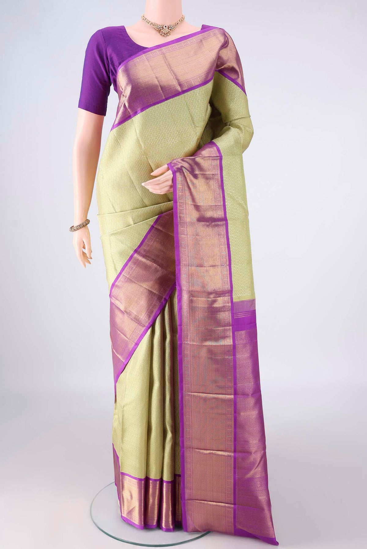 Pure Silk Pure Zari Pista Green Kanjivaram Saree with Jacquard design on the body and Zari Border.  displayed on a mannequin