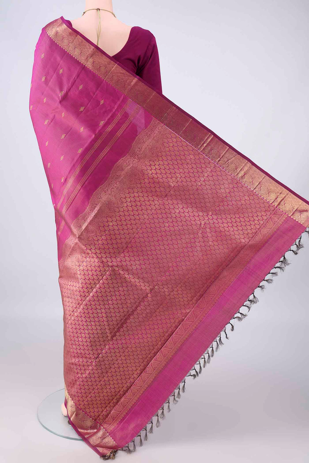 Flat view of Pure Silk Magenta Kanchipuram Saree with Zari Butta on the body and Zari Border. 