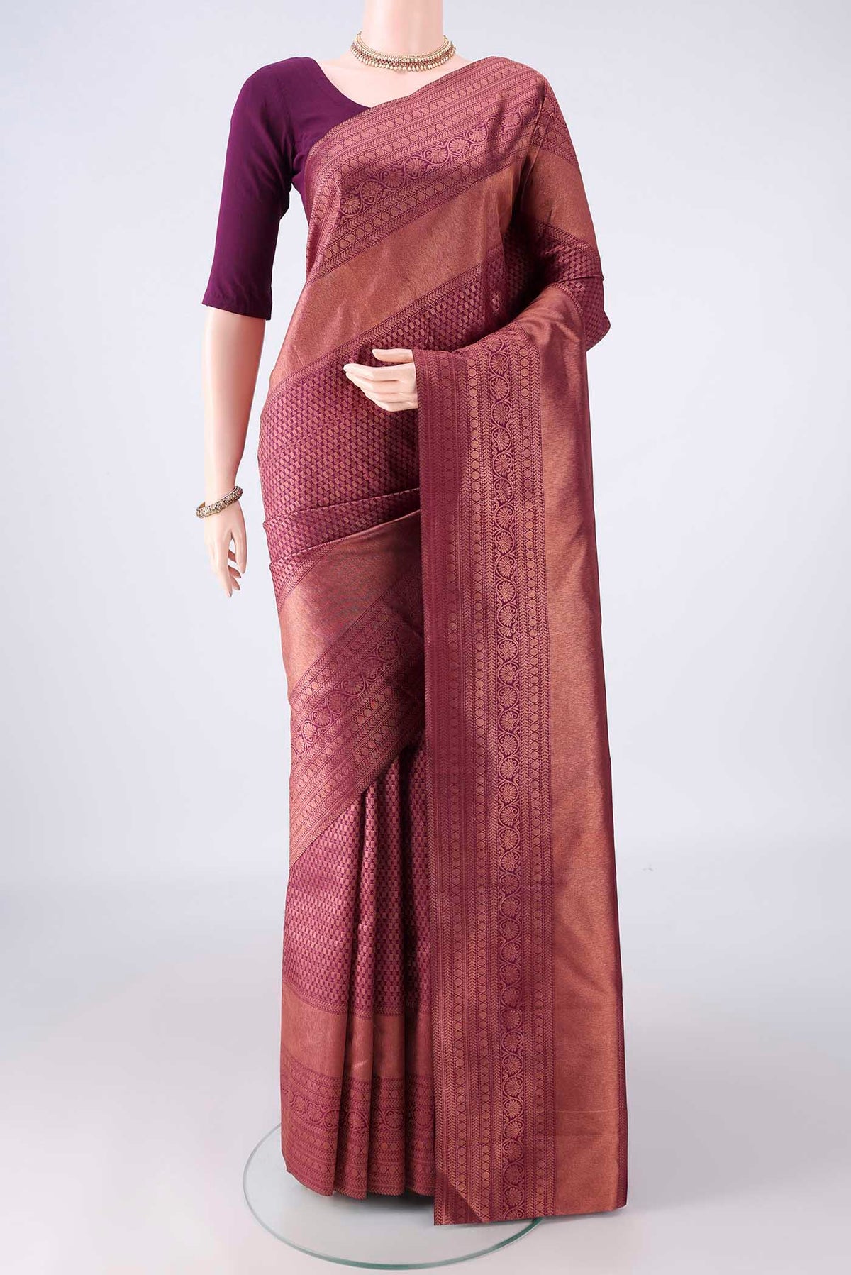 Pure Silk Magenta Kanchipuram Saree with Zari Brocade on the body and Zari Border.  displayed on a mannequin