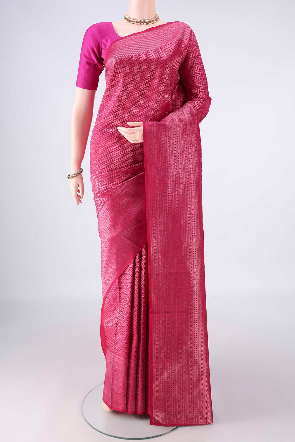 Pure Silk Rani Pink Kanchipuram Saree with Zari Brocade on the body and Zari Border.  displayed on a mannequin