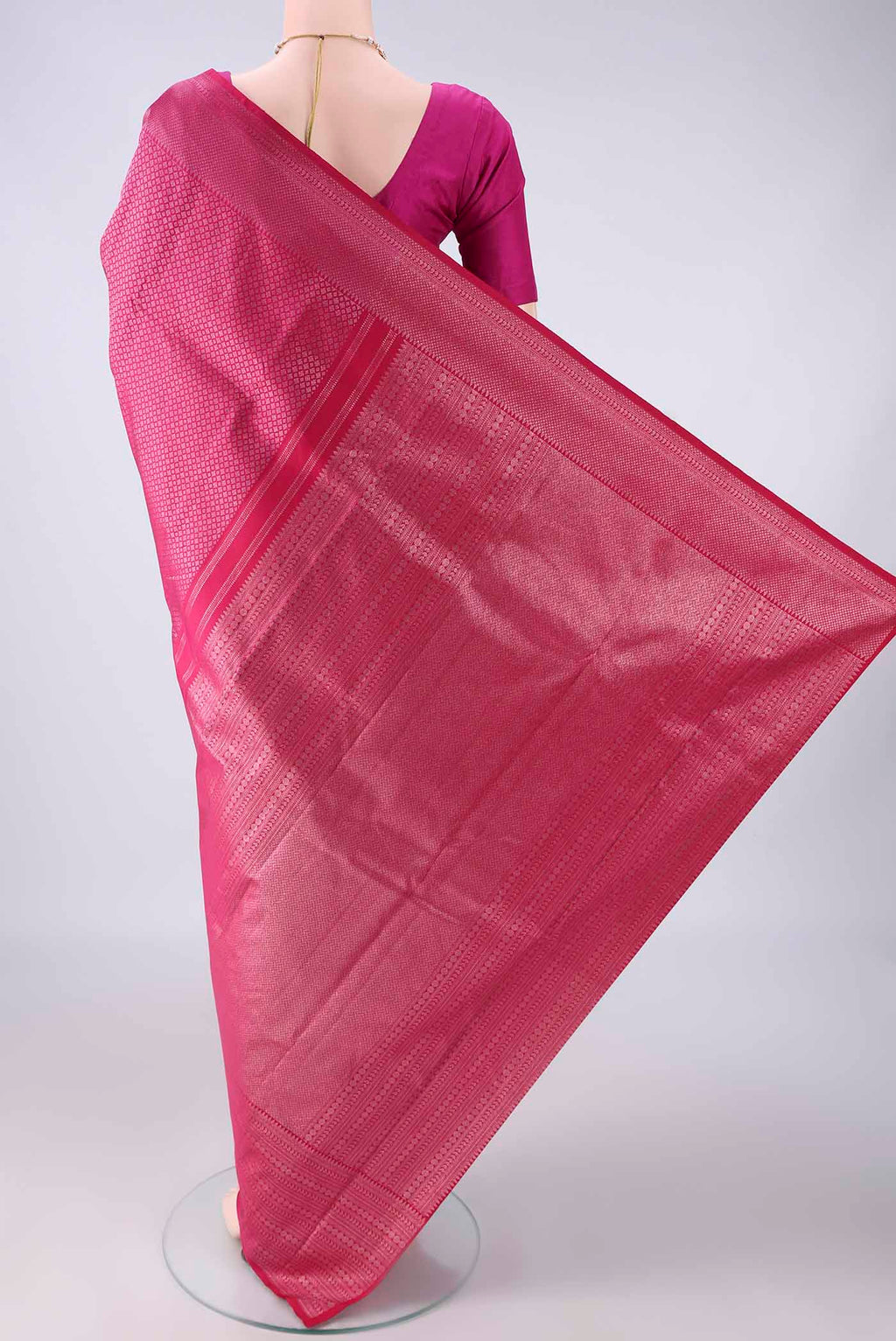 Flat view of Pure Silk Rani Pink Kanchipuram Saree with Zari Brocade on the body and Zari Border. 