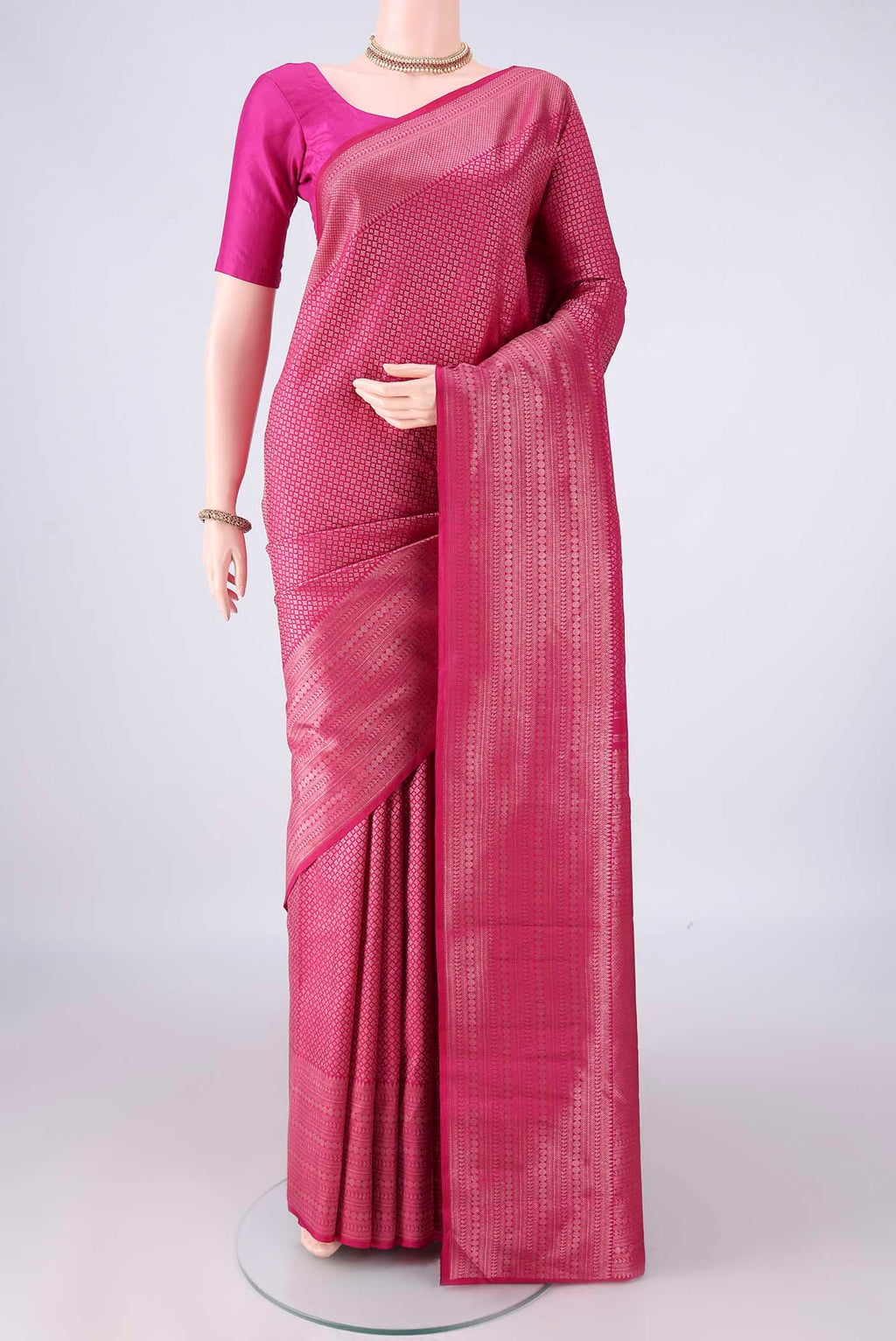 Pure Silk Rani Pink Kanchipuram Saree with Zari Brocade on the body and Zari Border.  displayed on a mannequin