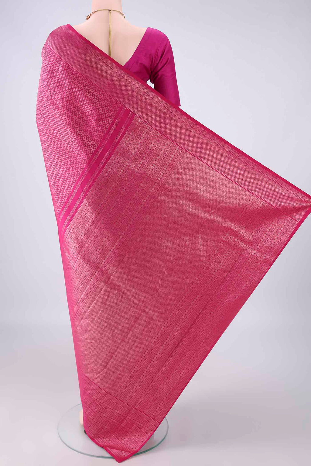 Flat view of Pure Silk Rani Pink Kanchipuram Saree with Zari Brocade on the body and Zari Border. 