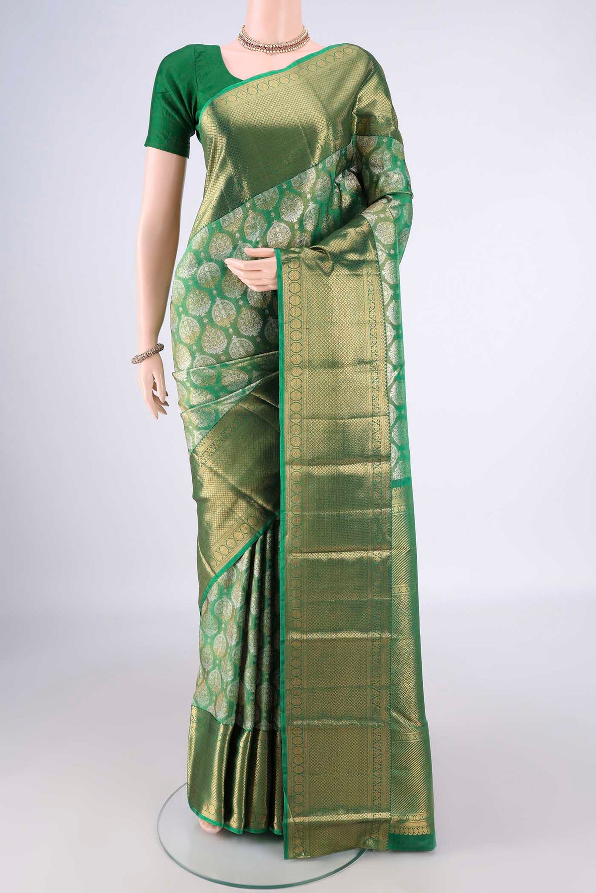 Green Dual Tone Kanjivaram Tissue Saree with Zari Brocade on the body and Zari Border.  displayed on a mannequin