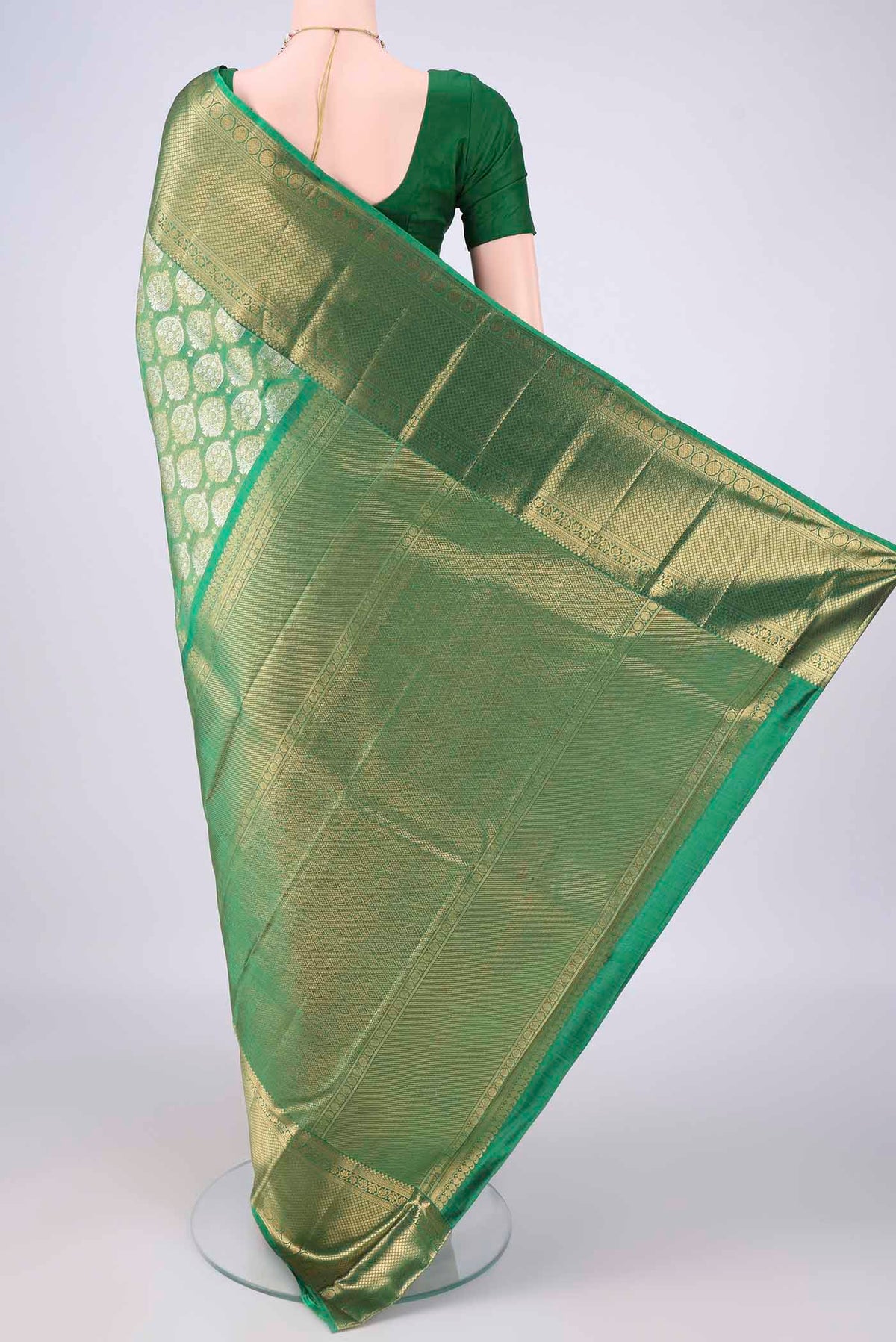 Flat view of Green Dual Tone Kanjivaram Tissue Saree with Zari Brocade on the body and Zari Border. 