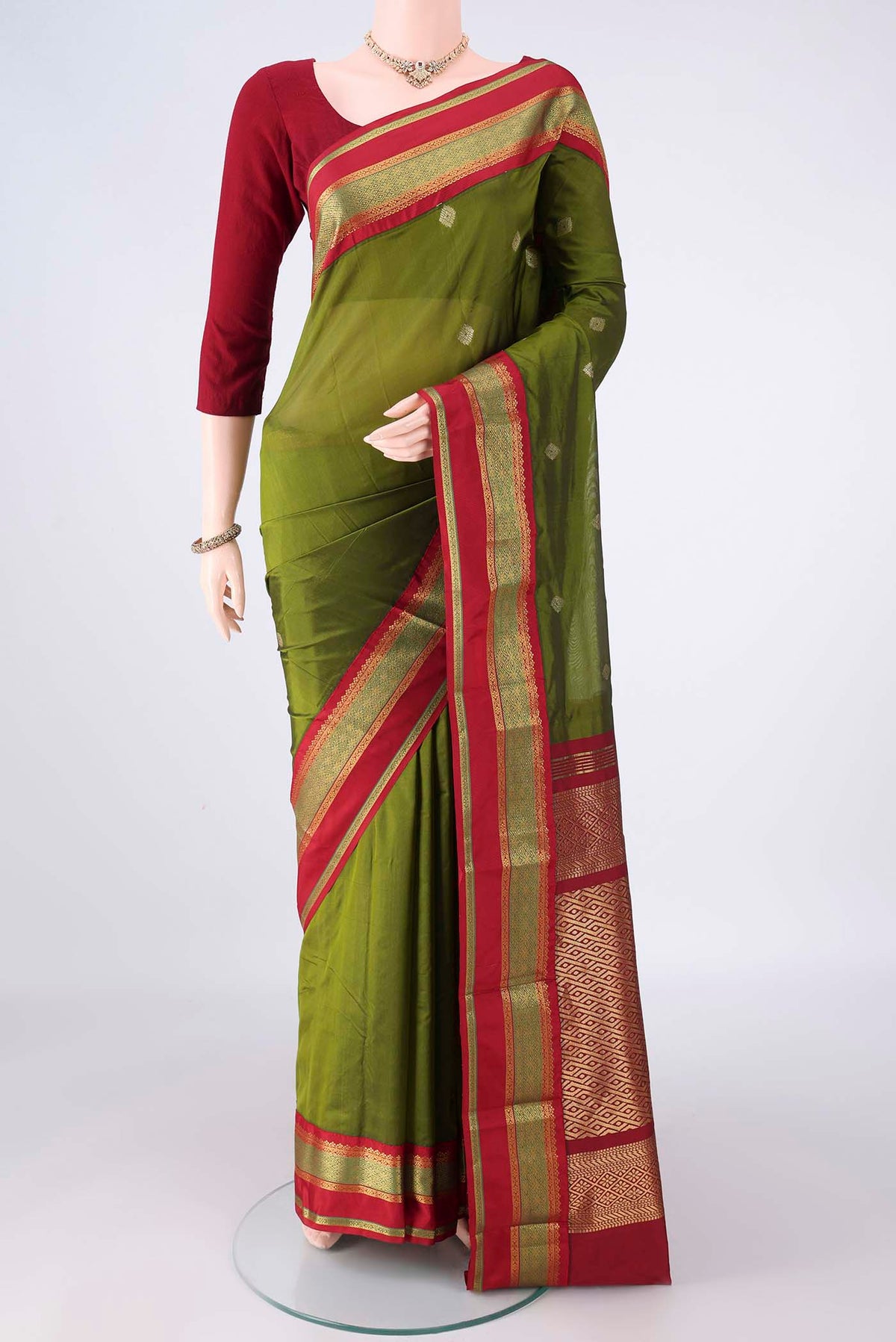 Mehandi Green Blended Bangalore Silk Saree with Zari Butta on the body and Zari Border.  displayed on a mannequin