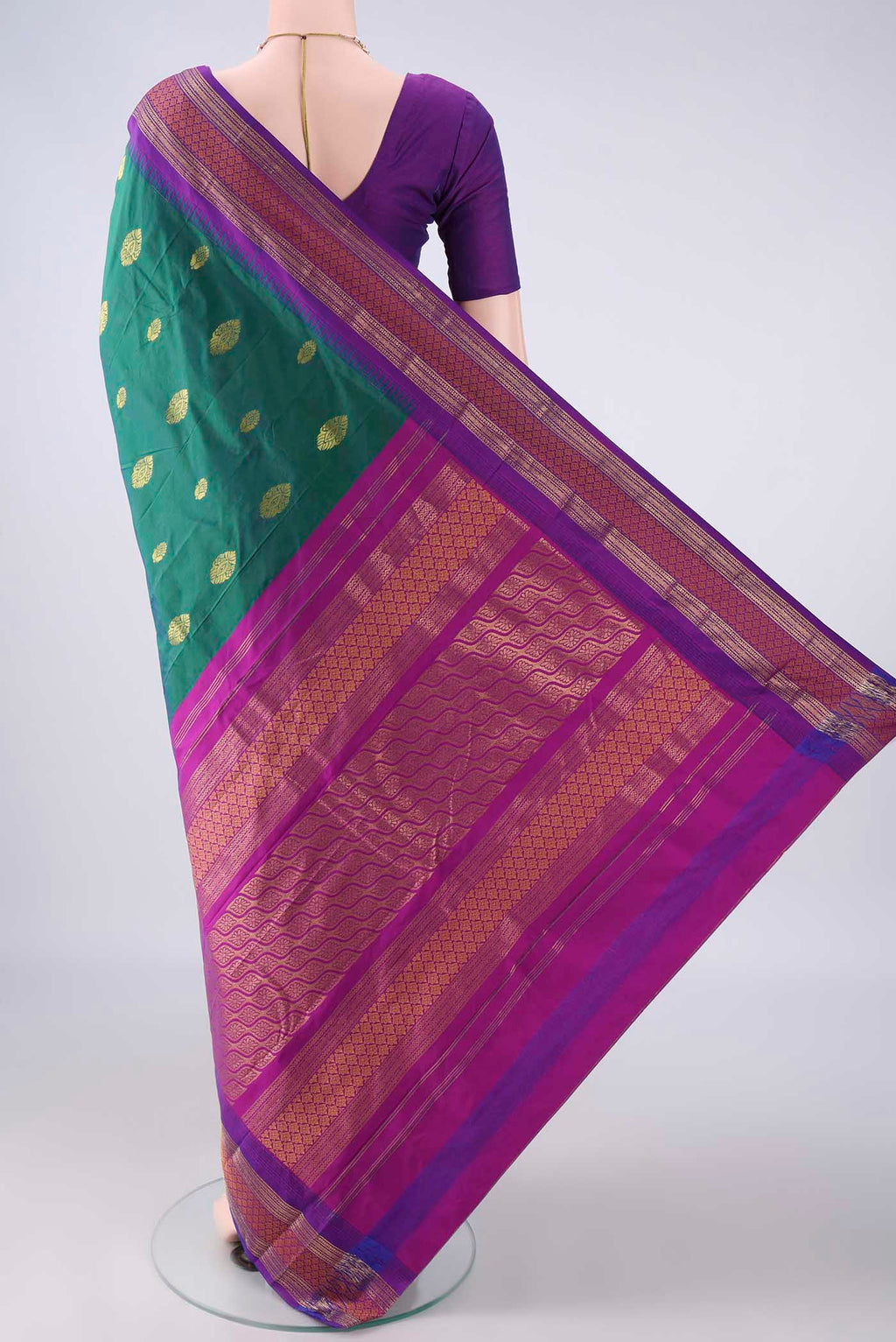 Flat view of Bottle Green Blended Bangalore Silk Saree with Zari Butta on the body and Zari Border. 