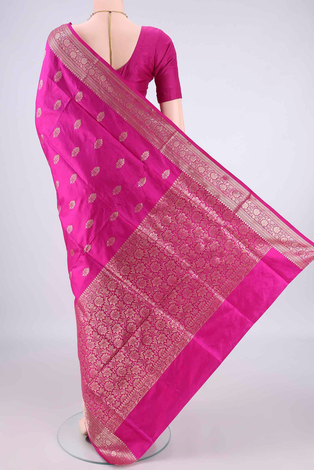 Flat view of Pure Silk Rani Pink Banarasi Katan Saree with Zari Butta on the body and Zari Border. 
