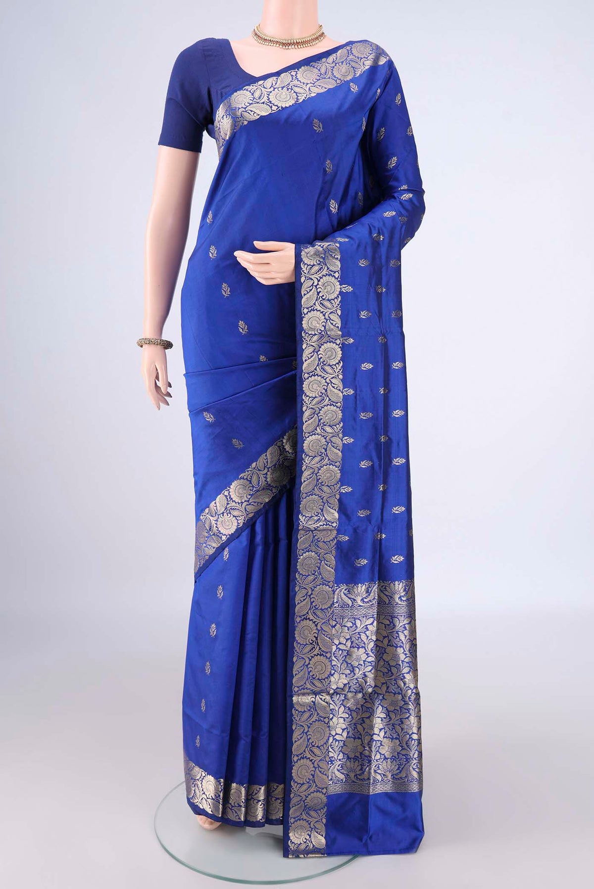 Pure Silk Royal Blue Banarasi Katan Saree with Zari Butta on the body and Zari Border.  displayed on a mannequin