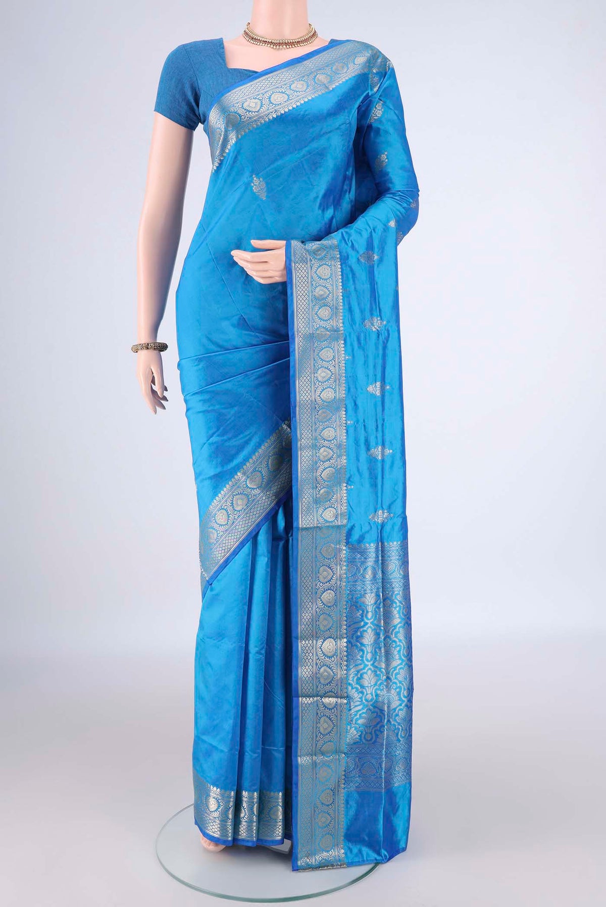 Pure Silk Electric Blue Banarasi Katan Saree with Zari Butta on the body and Zari Border.  displayed on a mannequin