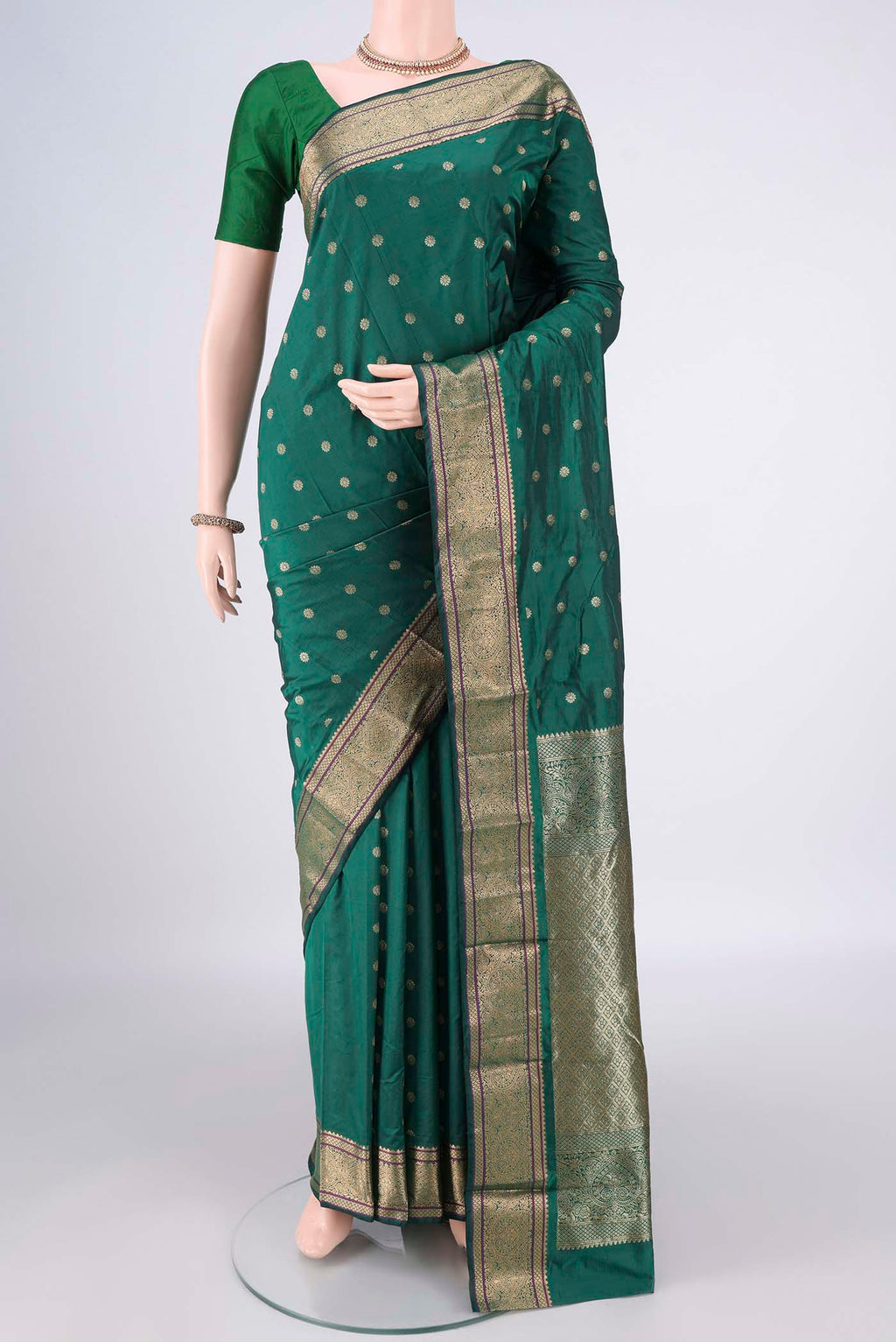 Bottle Green Blended Bangalore Silk Saree with Zari Butta on the body and Zari Border.  displayed on a mannequin