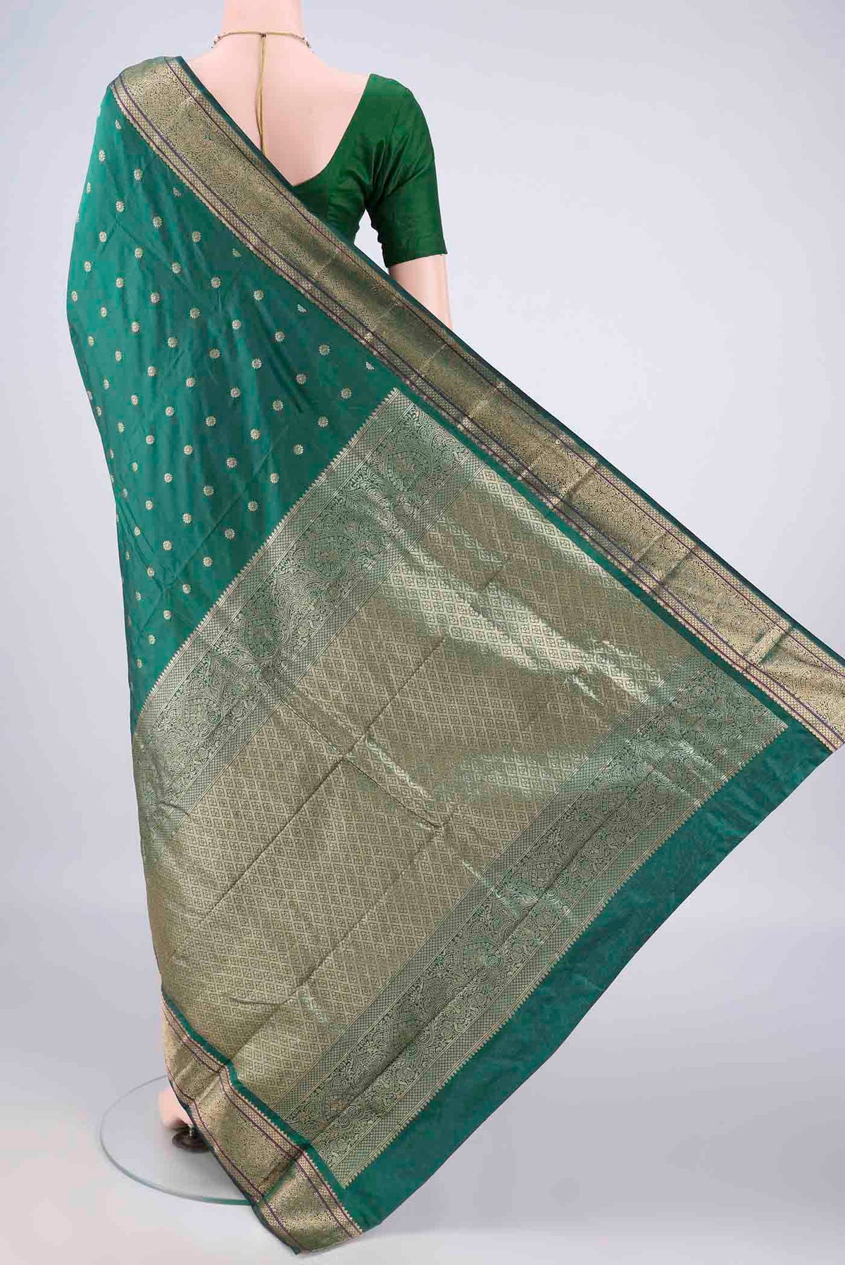 Flat view of Bottle Green Blended Bangalore Silk Saree with Zari Butta on the body and Zari Border. 