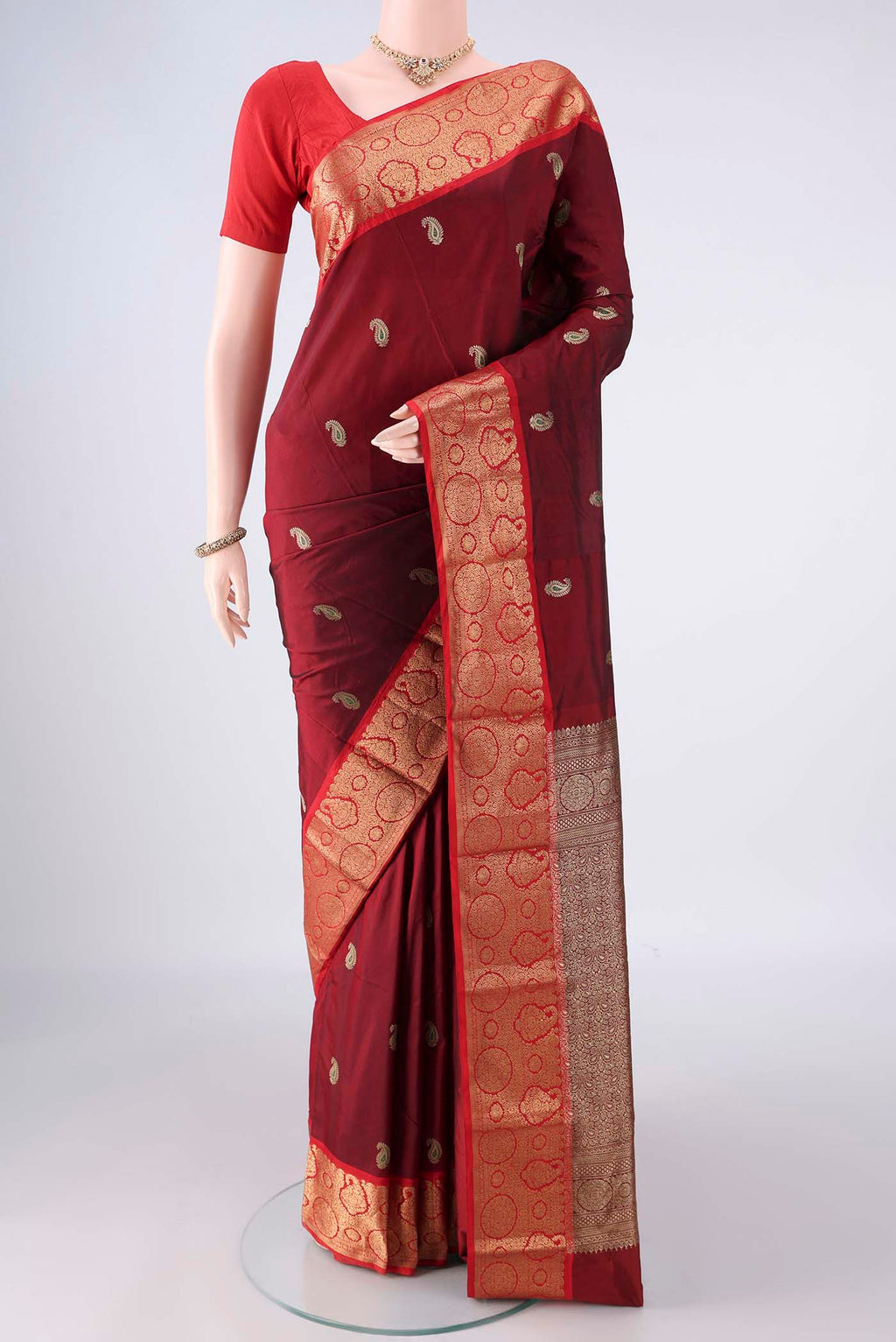 Maroon Blended Bangalore Silk Saree with Zari Butta on the body and Zari Border.  displayed on a mannequin