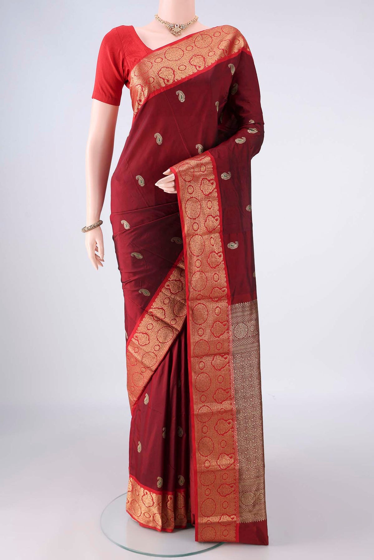 Maroon Blended Bangalore Silk Saree with Zari Butta on the body and Zari Border.  displayed on a mannequin