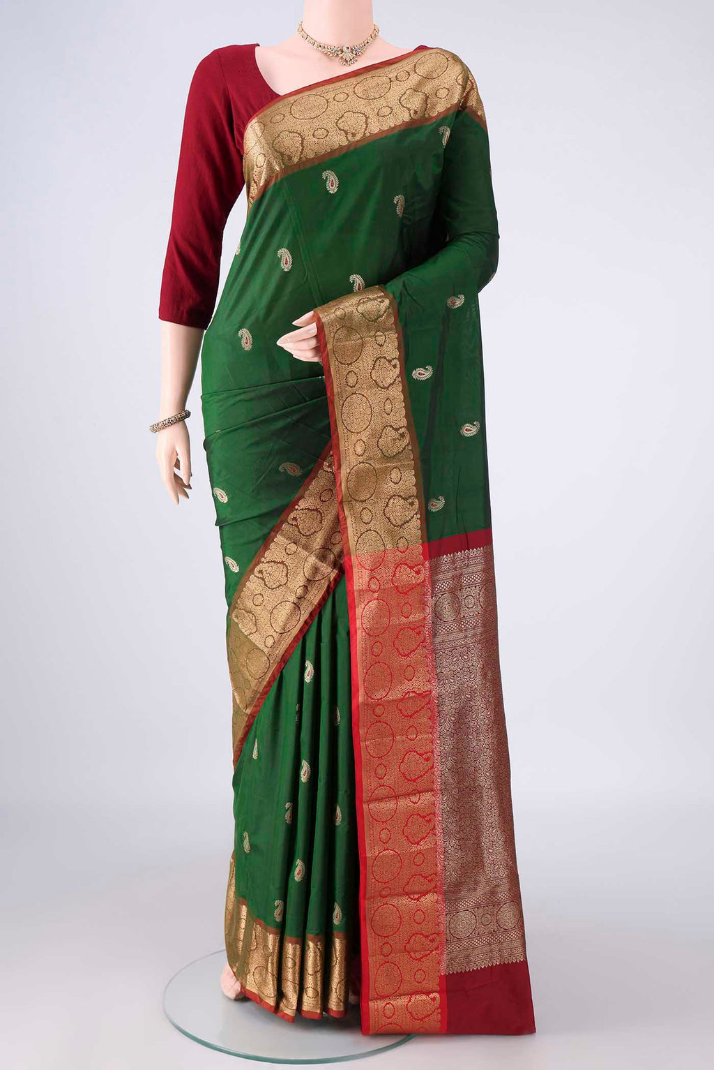 Green Blended Bangalore Silk Saree with Zari Butta on the body and Zari Border.  displayed on a mannequin