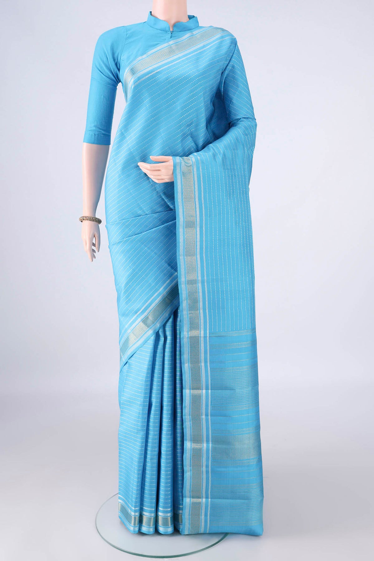 Pure Silk Pure Zari Sky Blue Kanchipuram Saree with Stripes on the body and Zari Border.  displayed on a mannequin
