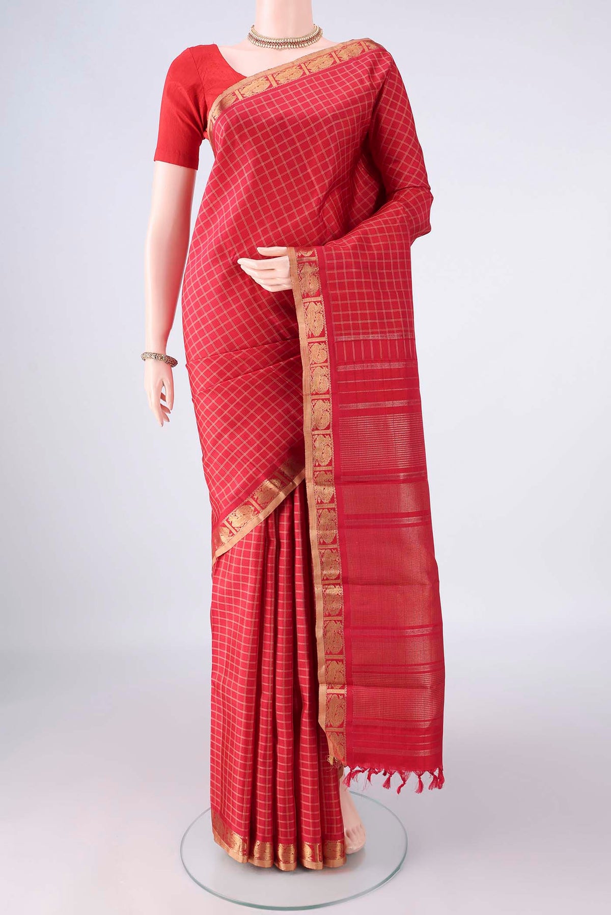 Pure Silk Pure Zari Red Kanchipuram Saree with Checked design on the body and Zari Border.  displayed on a mannequin