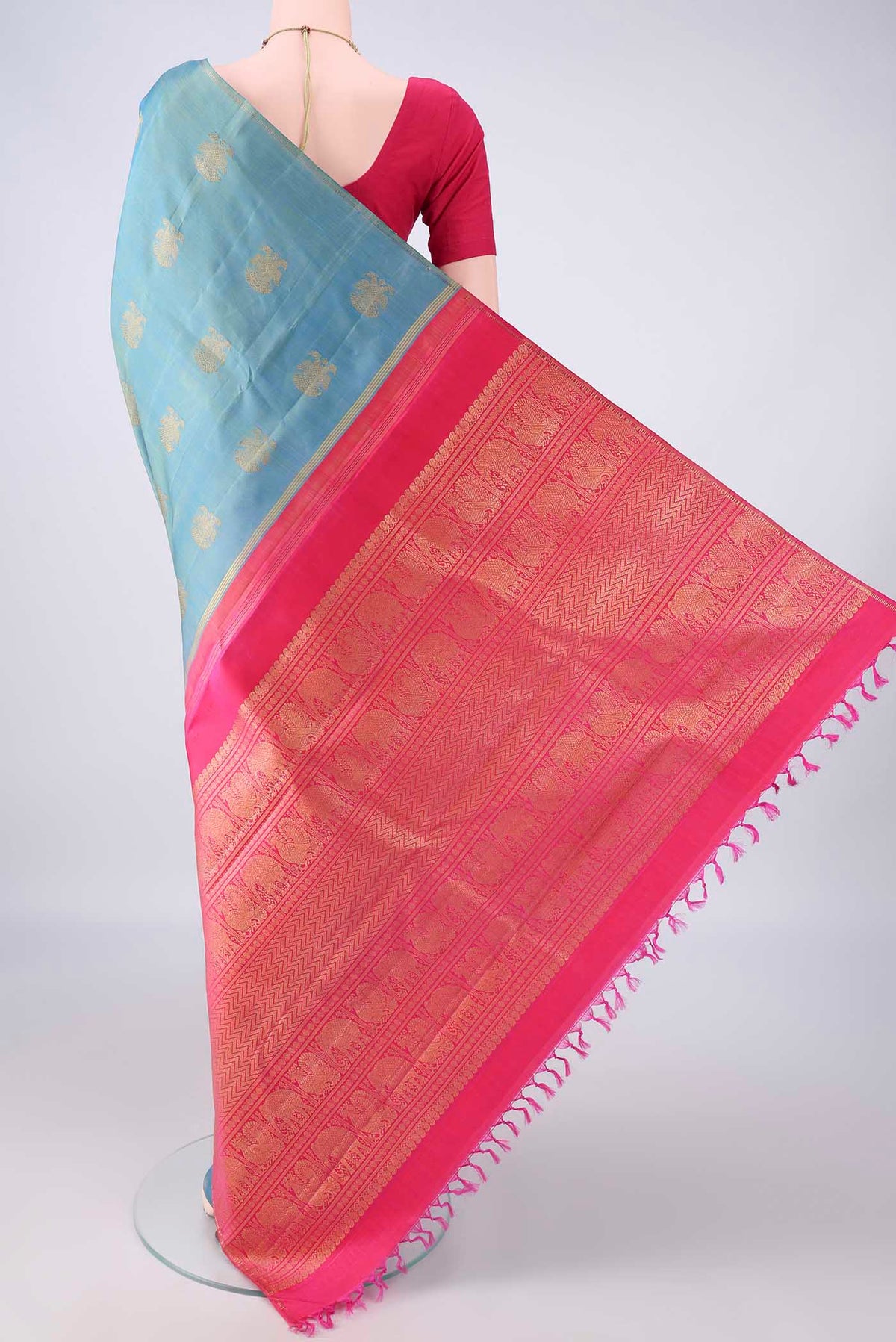 Flat view of Pure Silk Pure Zari Light Blue Dual Tone Kanchipuram Saree with Zari Butta on the body and Thin Zari Line. 