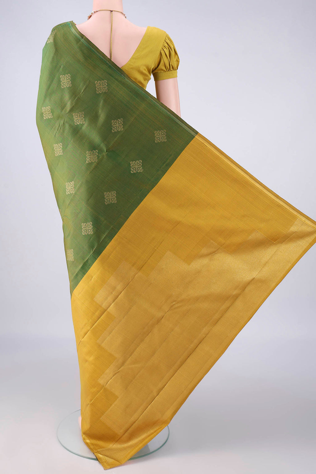 Flat view of Pure Silk Pure Zari Mehandi Green Kanchipuram Saree with Zari Butta on the body and Plain Border. 