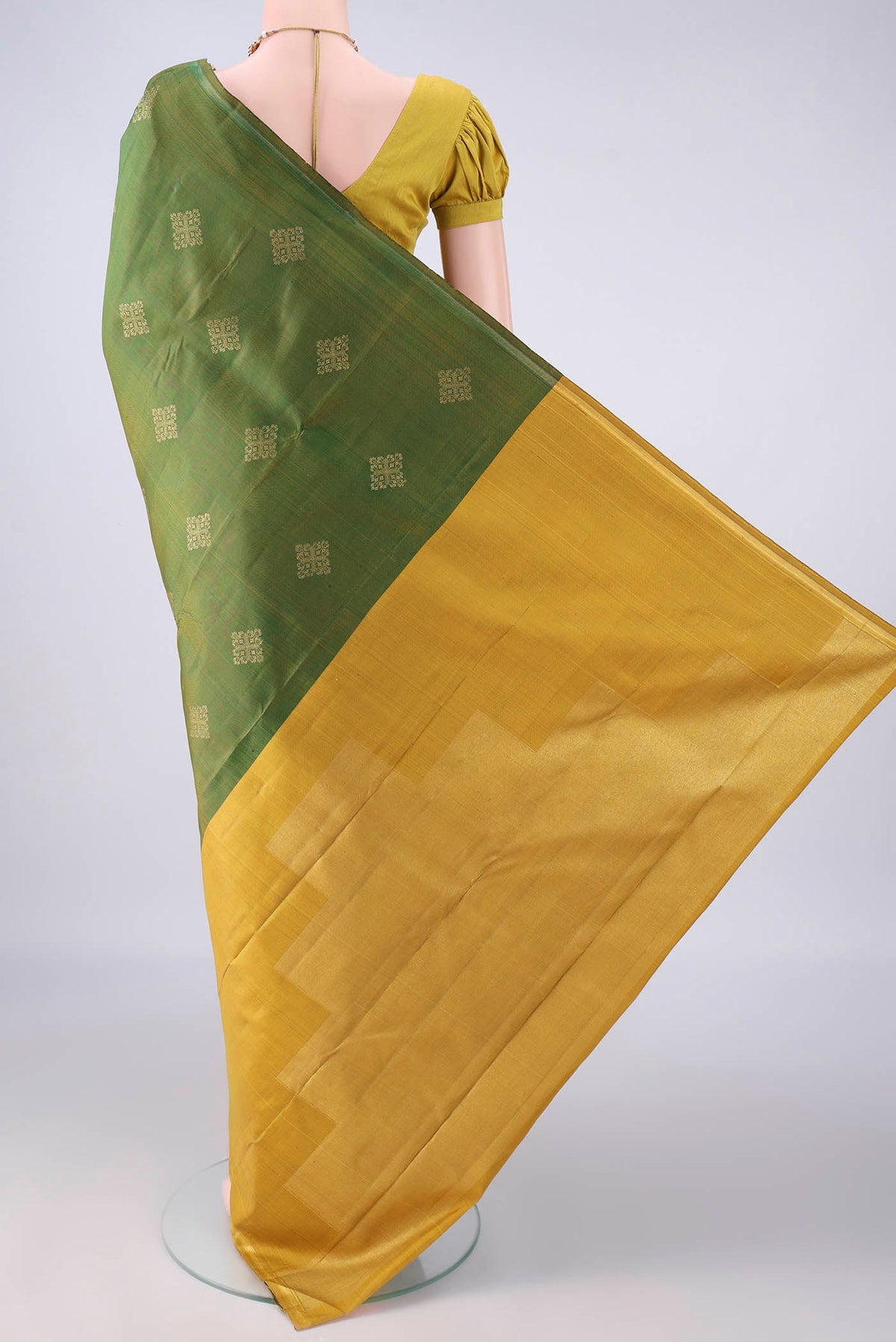 Flat view of Pure Silk Pure Zari Mehandi Green Kanchipuram Saree with Zari Butta on the body and Plain Border. 