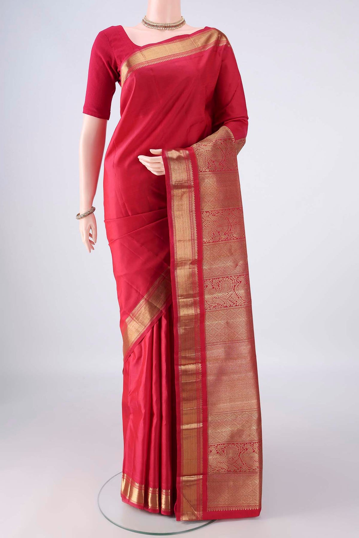 Pure Silk Pure Zari Red Kanjivaram Saree with Plain Body and Zari Border.  displayed on a mannequin