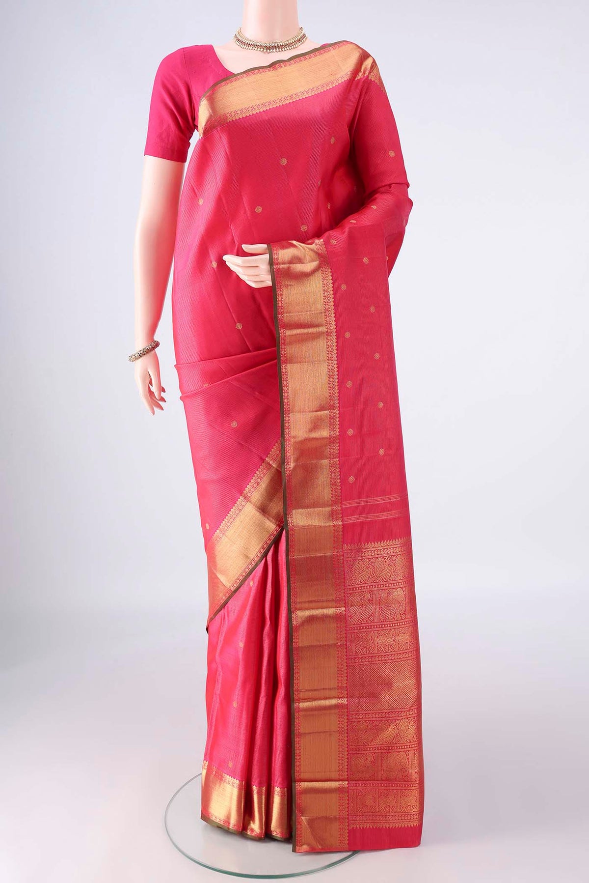 Pure Silk Pure Zari Dark Pink Kanjivaram Saree with Zari Butta on the body and Zari Border.  displayed on a mannequin