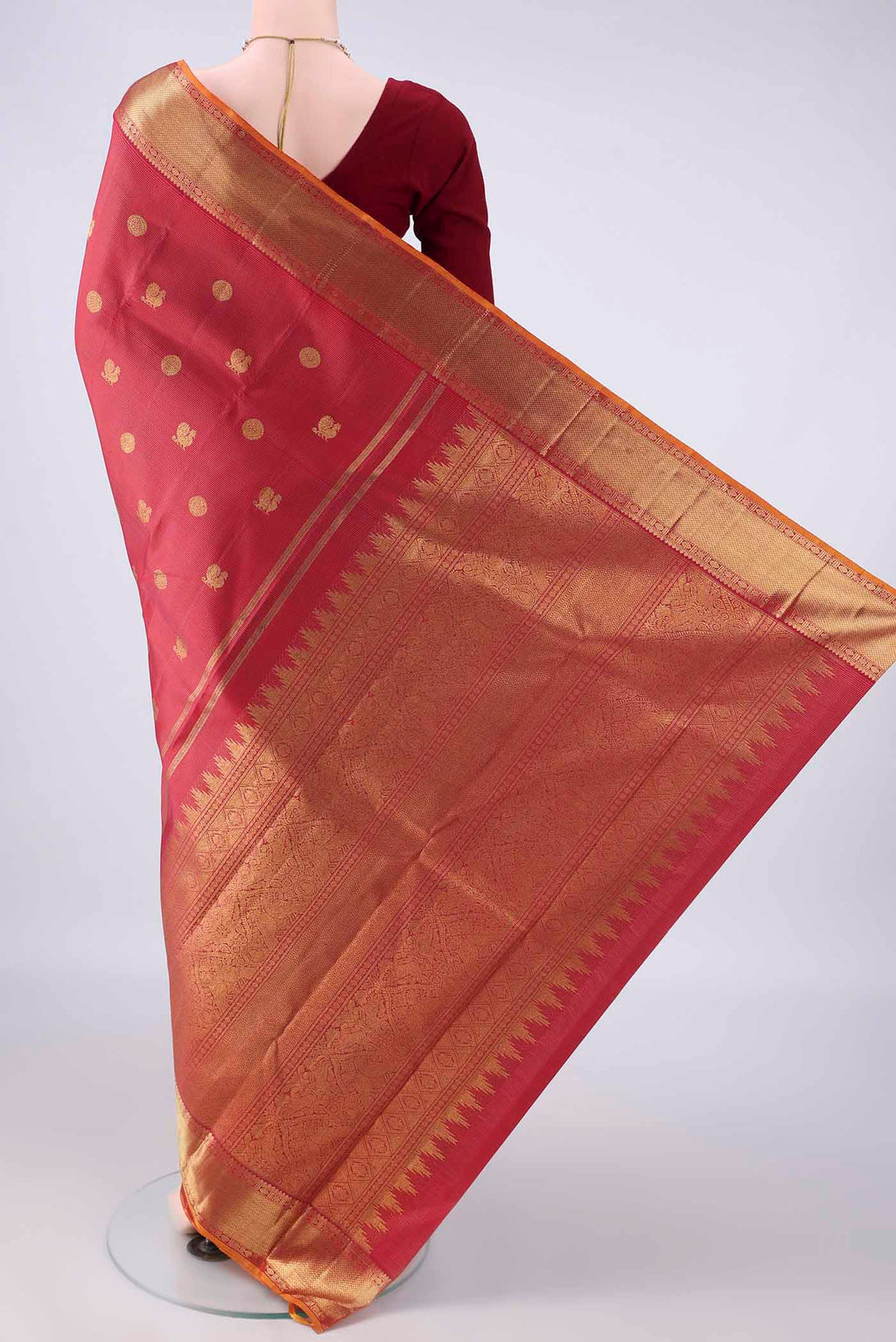 Flat view of Pure Silk Pure Zari Maroon Kanjivaram Saree with Zari Butta on the body and Zari Border. 