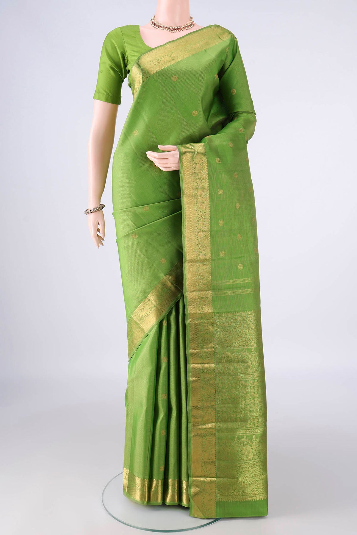 Pure Silk Pure Zari Light Green Kanjivaram Saree with Zari Butta on the body and Zari Border.  displayed on a mannequin