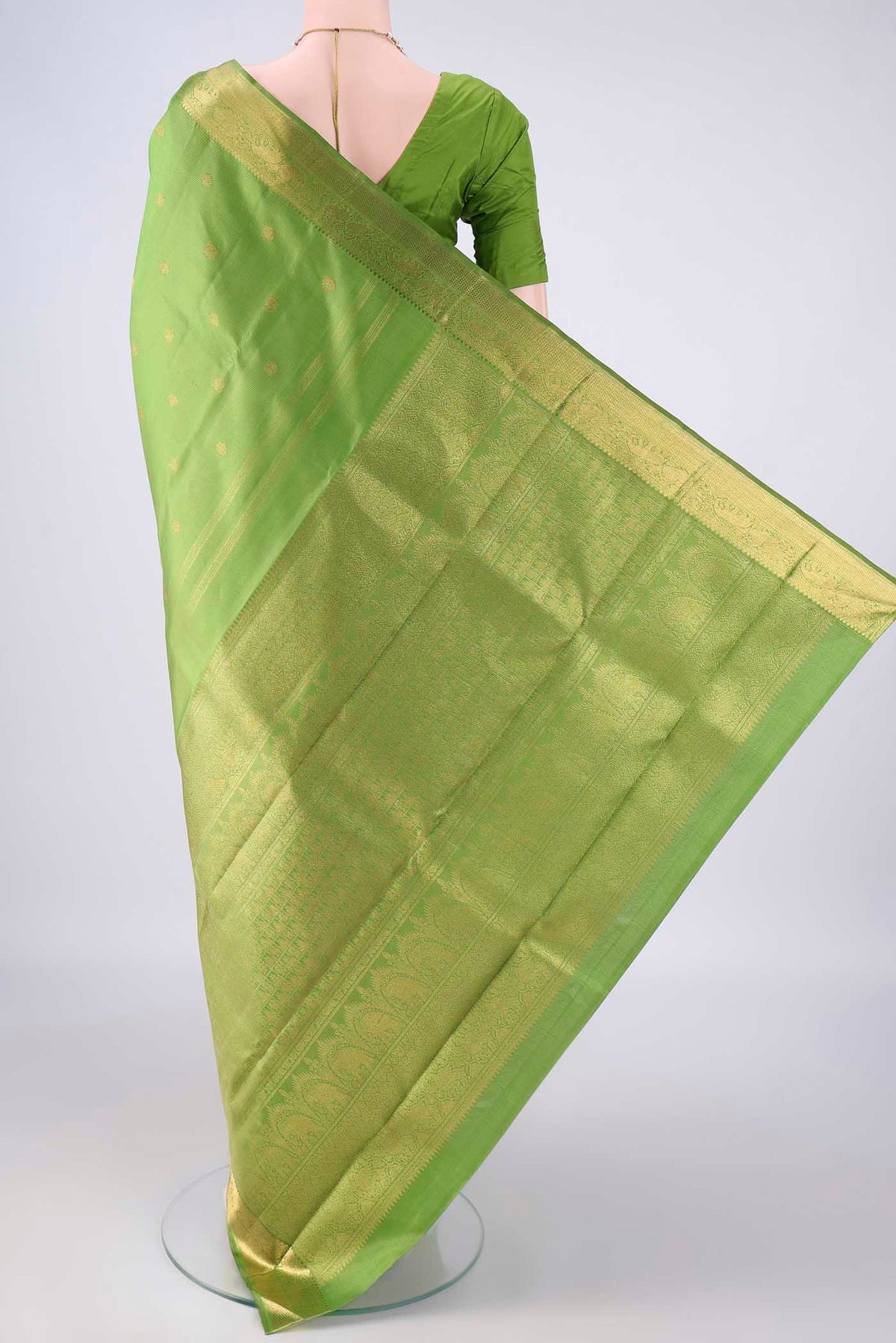 Flat view of Pure Silk Pure Zari Light Green Kanjivaram Saree with Zari Butta on the body and Zari Border. 