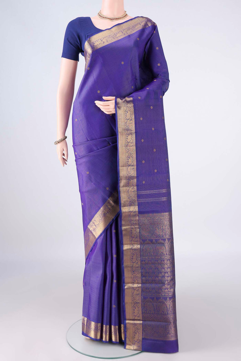 Pure Silk Pure Zari Royal Blue Kanjivaram Saree with Zari Butta on the body and Zari Border.  displayed on a mannequin