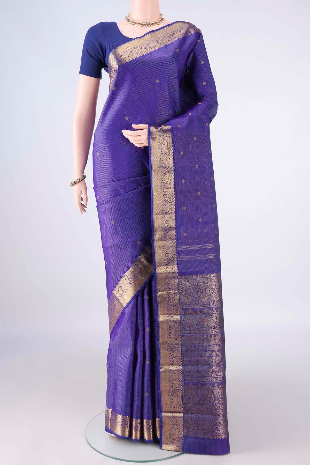Pure Silk Pure Zari Royal Blue Kanjivaram Saree with Zari Butta on the body and Zari Border.  displayed on a mannequin