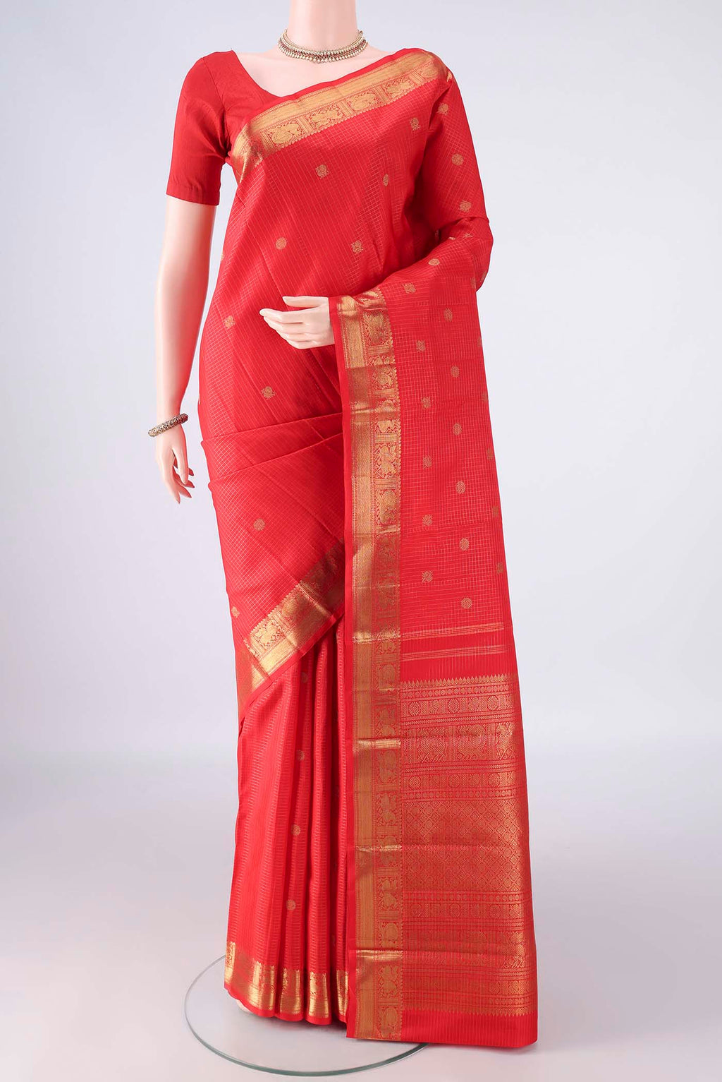 Pure Silk Pure Zari Red Kanjivaram Saree with Checked design on the body and Zari Border.  displayed on a mannequin