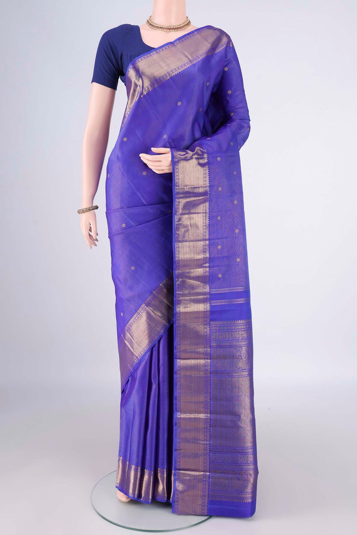 Pure Silk Pure Zari Royal Blue Kanjivaram Saree with Zari Butta on the body and Zari Border.  displayed on a mannequin