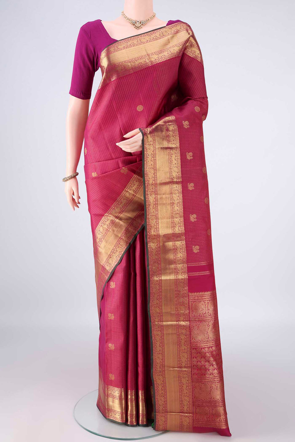Pure Silk Pure Zari Dark Pink Kanjivaram Saree with Checked design on the body and Zari Border.  displayed on a mannequin