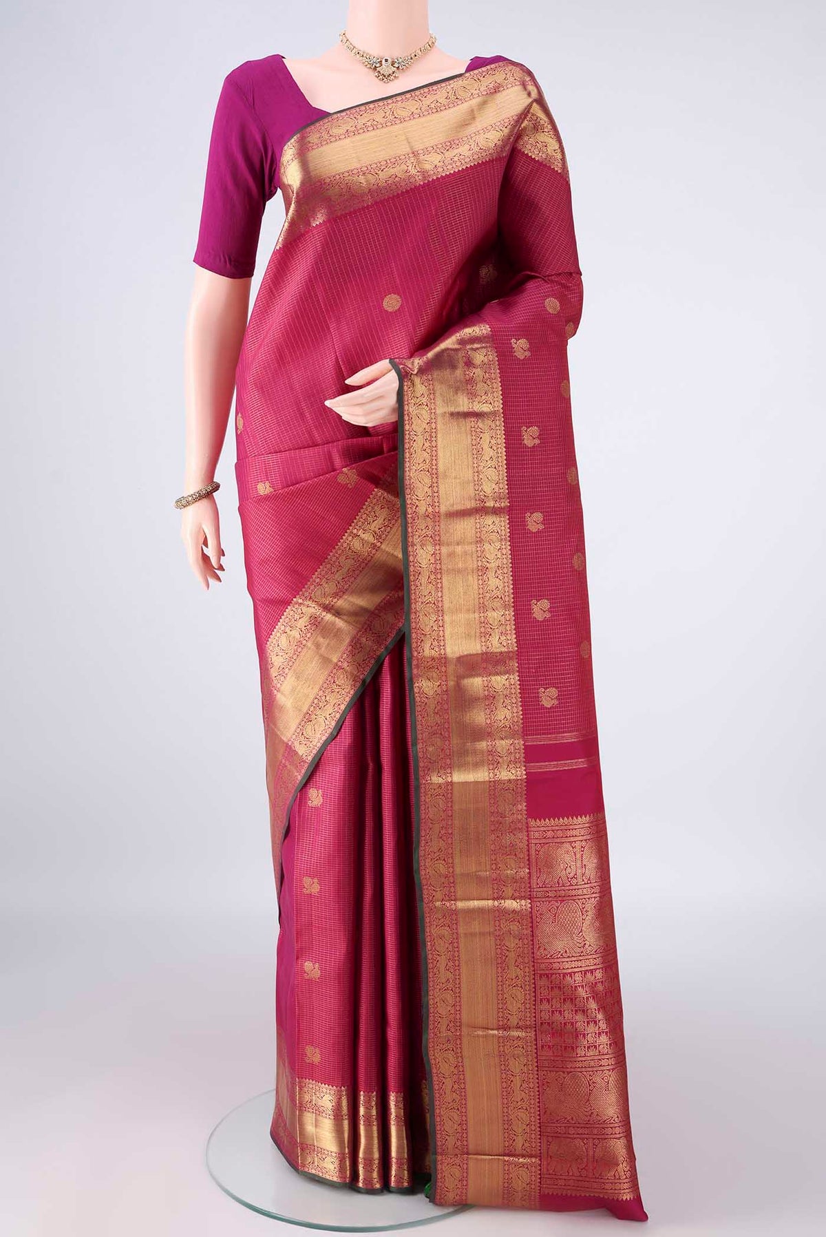 Pure Silk Pure Zari Dark Pink Kanjivaram Saree with Checked design on the body and Zari Border.  displayed on a mannequin