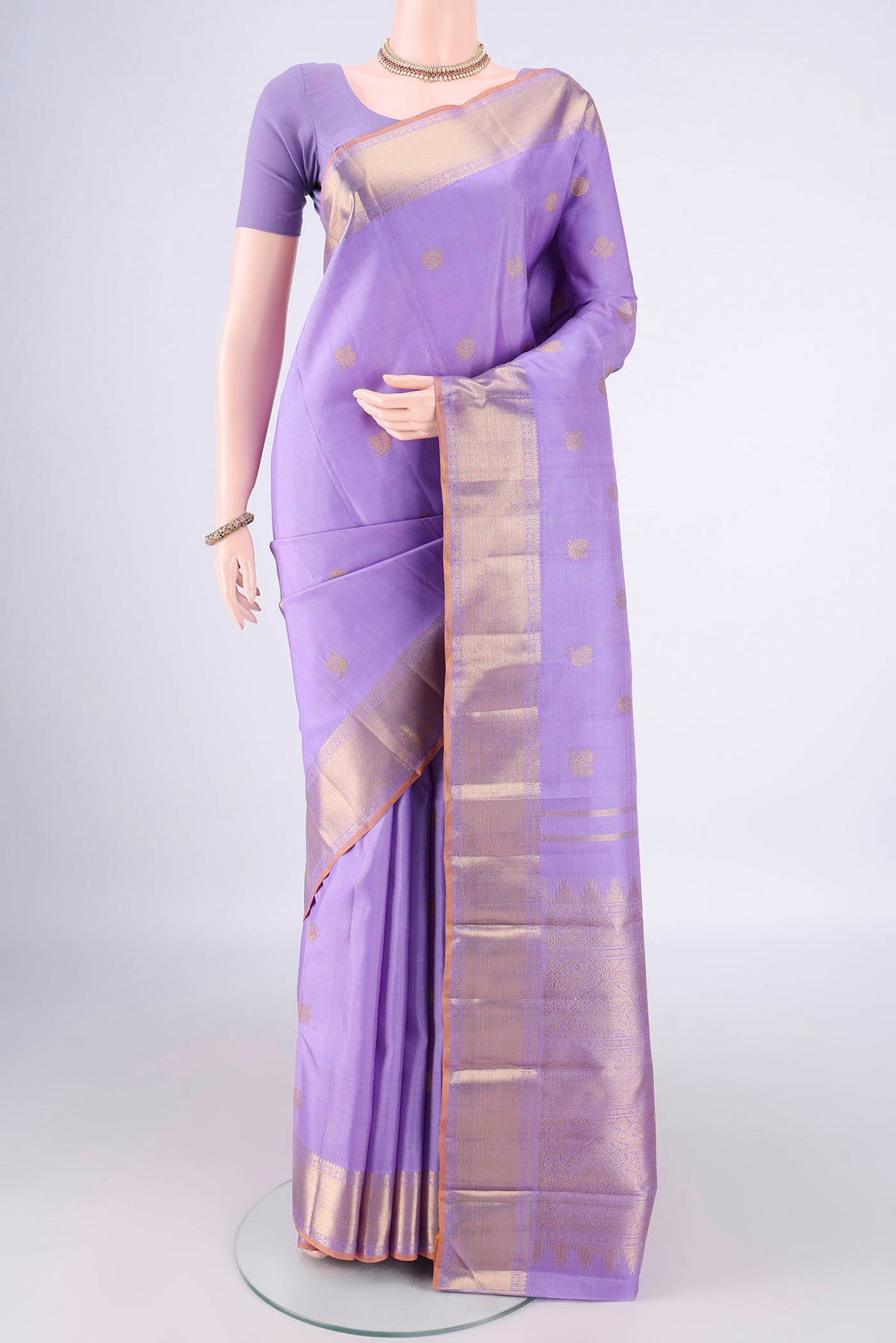 Pure Silk Pure Zari Lavender Kanjivaram Saree with Zari Butta on the body and Zari Border.  displayed on a mannequin