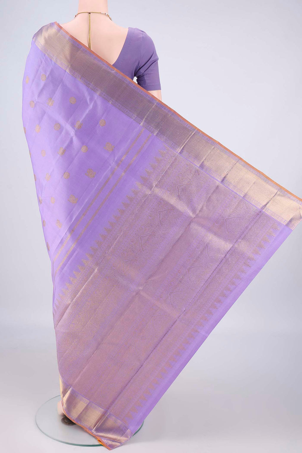 Flat view of Pure Silk Pure Zari Lavender Kanjivaram Saree with Zari Butta on the body and Zari Border. 