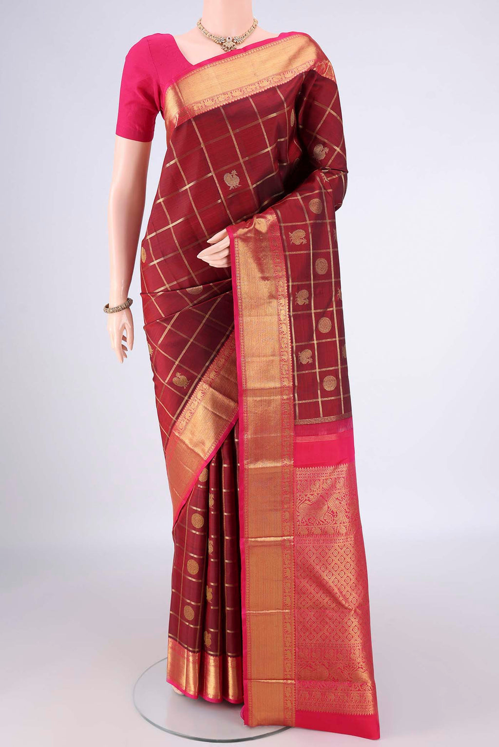 Pure Silk Maroon Kanjivaram Saree with Checked design on the body and Zari Border.  displayed on a mannequin
